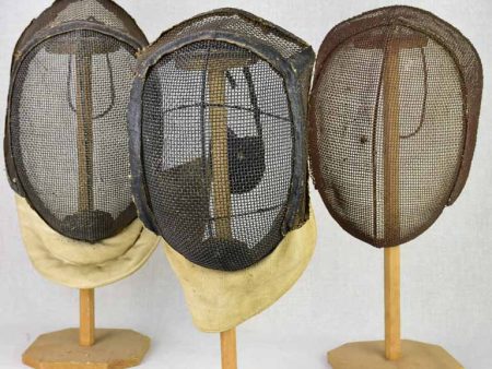 Collection of three antique French fencing masks on vintage hat stands Cheap