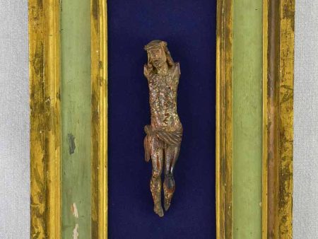 18th Century sculpted wooden Christ on blue fabric with a green and gold frame 11¾  x 18½  Fashion