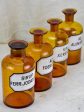 Four antique French apothecary jars with original glass lids - amber Hot on Sale